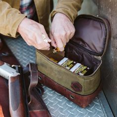 Out in the field, where every second counts, being prepared is key. Our Dakota shell bag is your reliable companion for any shooting adventure. Whether you’re at a trap shoot or on a hunt, this bag keeps your gear within arm’s reach. Made from water-resistant waxed canvas with a durable leather bottom and handle, it’s built to last as long as your gun. With capacity for up to 125 loose shells or five 25-count boxes, it’s the perfect size for your shooting needs. The wipeable nylon interior makes Shooting Rest, Buffalo Jackson, Shooting Bags, Trap Shooting, Shell Bag, Shotgun Shell, Sand Bag, Antique Brass Metal, Gear Bag