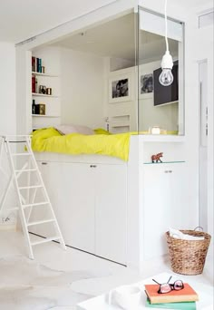 a white loft bed sitting next to a ladder