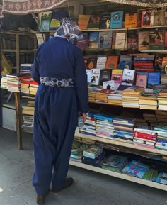 a man standing in front of a book stand