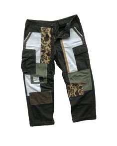 "Description: Uniqueness is here for those who love‼️ It's originally military pants in olive green herringbone pattern. Then, it's artistically full hand reworked and patched using several fabric materials and patterns, in order to make it unique and precious. However, its cargo style still remains as original since it contains multiple pockets like other military pants. Photos and videos describes the product better. So, just have a look-see at them all and read the special features below before you decide to purchase it.  Features: - Patchwork military pants. - Reworked cargo pants with multiple pockets. - Different fabric patterns and materials were patched as detailing.  - Full hand sewing stitches. - Herringbone pattern fabric. - Relaxed fit. Size: Waist: 33 - 37\" (Adjustable)  Hips Olive Military Cargo Pants With Patch Pockets, Military Style Olive Cargo Pants For Streetwear, Olive Military Cargo Pants For Streetwear, Olive Military Style Pants For Streetwear, Utility Style Patchwork Bottoms For Streetwear, Utility Patchwork Bottoms For Streetwear, Khaki Cotton Patchwork Bottoms, Utility Style Cotton Pants With Patchwork, Cotton Utility Pants With Patchwork