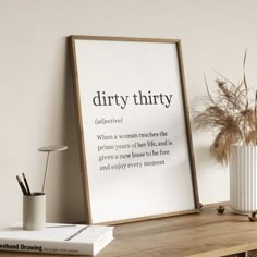 there is a sign that says dirty thirty on the wall next to a vase with dry grass in it