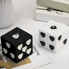 two black and white dices sitting next to each other on top of a table