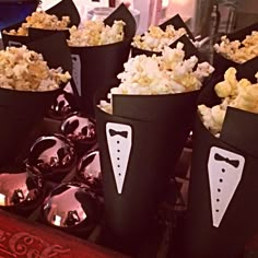 several buckets filled with popcorn and bow ties