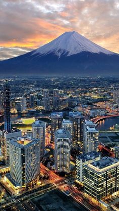 an aerial view of a city with a mountain in the background