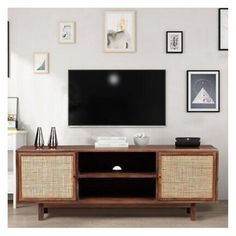 a flat screen tv sitting on top of a wooden entertainment center