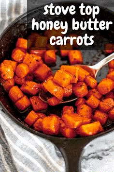 a skillet filled with cooked carrots on top of a table