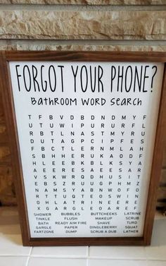 a bathroom word search sign in front of a stone wall with the words forgot your phone?