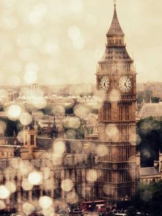 the big ben clock tower towering over the city of london on a hazy day in england