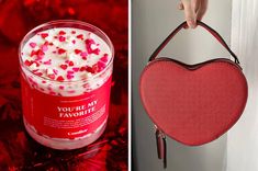 a red heart shaped bag hanging from the side of a wall next to a cup filled with white frosting