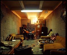 a living room filled with lots of furniture and musical instruments