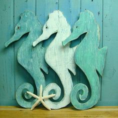 two seahorses are standing next to each other on a shelf with starfish