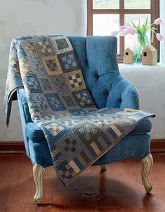 a blue chair with a quilt on it