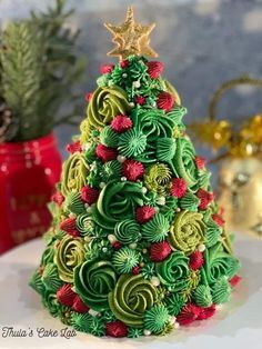 a christmas tree made out of green and red spirals on top of a table