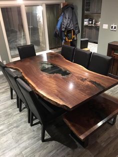 a large wooden table with black chairs around it