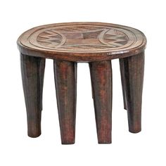 a wooden stool with an intricate design on it