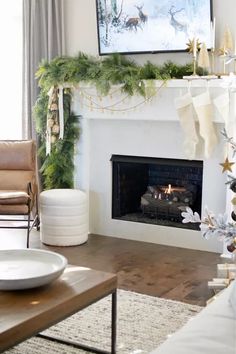 a living room with a fireplace decorated for christmas