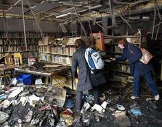 two people looking at books in a room full of rubble and debris, with one person holding a book bag