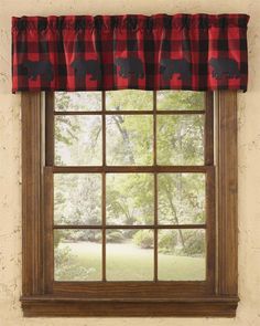 a window with a red and black buffalo print valance