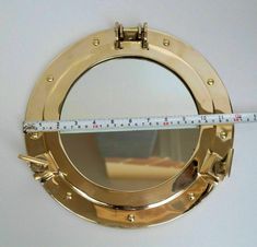 a close up of a mirror with a measuring tape