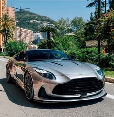 a silver sports car is parked on the street