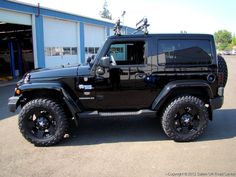 a black jeep parked in front of a building