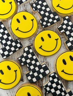 decorated cookies with smiley face and checkerboard pattern on them are arranged in rows