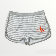 Brand New With Tags! Calvin Klein Child’s 6x Grey Striped Logo Shorts Stretchy Elastic Band Extremely Comfortable Stretchy Polyester Orange Ck Printed Logo Size 6x Can Be Used As Pj Bottoms Or Comfy Lounge Shorts #611 B2 White Stretch Bottoms For Playwear, Casual Letter Print Playwear Shorts, White Cotton Playwear Shorts, Trendy White Cotton Pajama Shorts, Sporty Calvin Klein Summer Shorts, Trendy Calvin Klein Summer Bottoms, Calvin Klein Sporty Shorts For Summer, Calvin Klein Sporty Summer Shorts, Calvin Klein Cotton Bottoms With Elastic Waistband