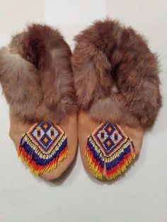 These Moccasins were handmade by me. They are size 5. They are fur lined.They have a beaded toe plug that is fringed on each toe. The leather is gold cow Suede. They were stitched together with sinew. Very strong stuff! This what the web of a dream catcher is made of. I made myself a pair of these moccasins  about 12 years ago and they are still in good shape and worn a lot. Traditional Brown Moccasins For Festival, Traditional Brown Hand-stitched Moccasins, Baby Moccasins, American Leather, Pow Wow, Native American Fashion, American Fashion, American Beauty, Rabbit Fur