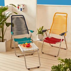 two lawn chairs sitting on top of a wooden floor