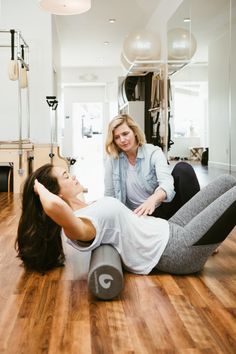 two women sitting on the floor in a room