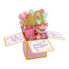 a birthday card in a box with the number 40 on it and balloons, confetti, and gifts