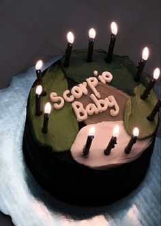 a birthday cake with candles on it that says scope baby in white letters and green frosting