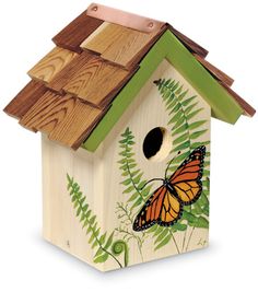 a wooden birdhouse with a butterfly painted on it