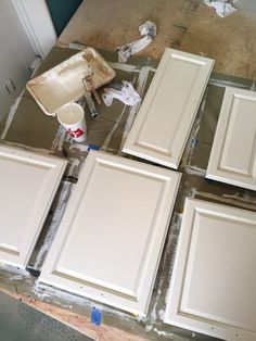 the cabinets are being painted white and ready to be installed