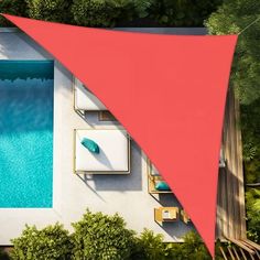 an aerial view of a swimming pool and patio area with a red shade over it