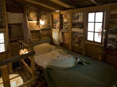 a bed in a room with wooden walls