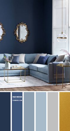 a living room with blue walls and gold accents in the color scheme, along with two mirrors on the wall