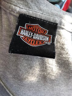 the harley davidson logo is shown on a gray shirt