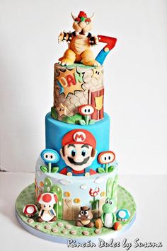 a three tiered cake decorated with mario and other characters