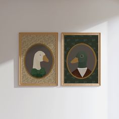 two framed paintings of ducks are on the wall