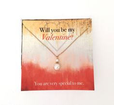 a valentine's day card with a heart shaped pendant on it and the words will you be my valentine?