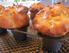 three muffins sitting on top of a metal tray next to another muffin