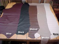 the table is covered with many different colored fabrics