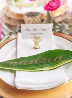 an image of a table setting with place cards on the plate and name tags attached to it