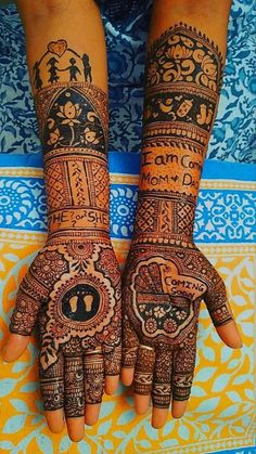 two hands with henna tattoos on them