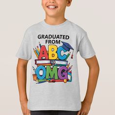 a young boy wearing a t - shirt that says, graduated from abc to omg