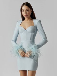 a woman in a dress with feathers on it