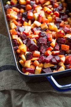 a casserole dish with beets and potatoes in it