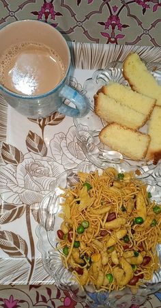 a glass plate topped with bread and salad next to a cup of coffee on top of a table