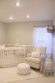 a baby's room with a crib, rocking chair and white rugs